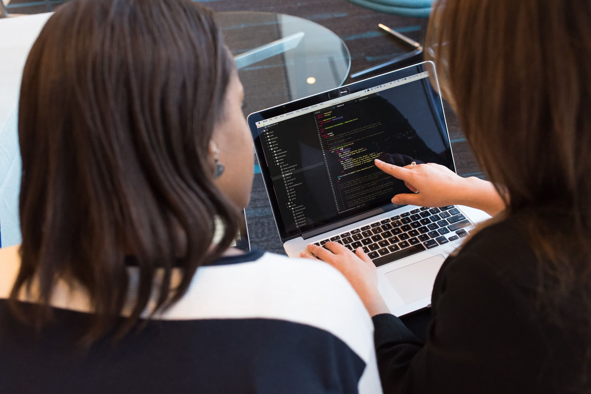 Business professionals collaborating at computers in modern office